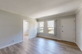 Located at 4811 West Slauson Avenue in the desirable View Park-Windsor Hills neighborhood of Los Angeles, this thoughtfully designed one-bedroom, one-bathroom unit offers an efficient and comfortable single-floor layout. Light-toned hardwood flooring flows throughout, lending a clean, cohesive aesthetic to the entire space.

The living room is bright and welcoming, featuring crown molding, neutral gray walls, and dual windows that invite generous natural light. An open sightline connects the living area to the kitchen, which is outfitted with rich, dark espresso cabinetry, sleek brushed nickel hardware, white quartz countertops, a double stainless steel sink, and ample upper and lower cabinet storage.

The bedroom is a comfortable retreat with two windows providing plentiful natural light and outdoor views, a ceiling fan for year-round comfort, and a dedicated closet with built-in shelving. A second closet and a hallway provide additional storage throughout the unit.

The bathroom features a full bathtub and shower combination with a window for natural ventilation and light. Throughout the unit, clean white trim and soft gray walls create a modern, move-in-ready ambiance that is both functional and inviting.