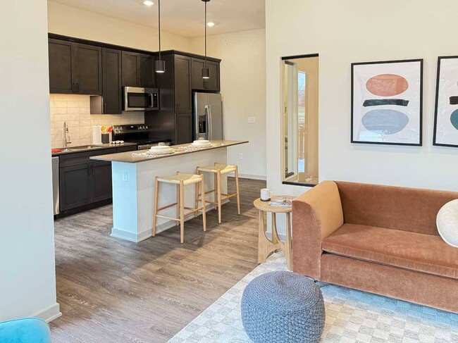 Experience the seamless flow of our Fox studio apartment, where the stylish kitchen opens up to a cozy living areaperfect for cooking, dining, and relaxing in comfort. - Brynwood at Wilderness Ridge