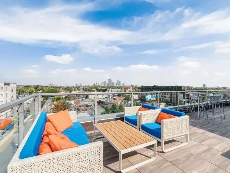 Rooftop lounge area with seating and city views.
