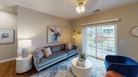Located at 300 Starboard Side Ln in Rochester, NY, this single-floor residence offers a thoughtfully designed layout with a cohesive, contemporary aesthetic. The open-concept living area is anchored by hardwood-style flooring and features a sliding glass door that floods the space with natural light while providing direct access to a balcony with outdoor views of the surrounding community. A ceiling fan and neutral-toned walls contribute to the room's comfortable, inviting atmosphere.

The kitchen is a functional centerpiece, outfitted with rich dark-wood cabinetry, granite countertops, stainless steel appliances—including a refrigerator, dishwasher, and over-range microwave—and a double sink. A dining area with windows sits adjacent, enhancing the sense of openness.

The bathrooms continue the granite and dark-wood cabinetry theme. The primary bath features a dual-sink vanity with a large mirror, wood-look flooring, and a separate shower area. A secondary bathroom offers similar finishes with a window for natural light.

The bedrooms are carpeted and well-proportioned. The primary bedroom includes large windows with blinds and curtains, while secondary bedrooms offer ample space and closet storage, making the residence as practical as it is polished.