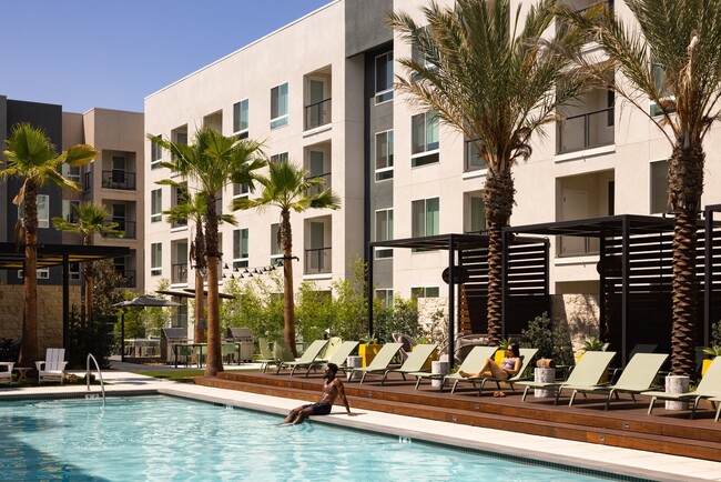 Pool deck with cabanas, waterfall spa, and fireplace seating - Acadia