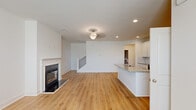 Located at 1801 Hamilton Rd in LaGrange, Georgia, this two-story home offers three bedrooms and four bathrooms across a well-designed layout. The main floor features an open-concept living room and kitchen, anchored by warm light wood-tone flooring and recessed lighting throughout. A classic fireplace with a white surround adds a focal point to the living area, while a decorative chandelier adds a touch of elegance overhead. The kitchen is outfitted with white shaker-style cabinetry, granite countertops, stainless steel appliances, and a center island with a built-in sink — ideal for both cooking and entertaining. A pantry closet provides additional storage just steps from the kitchen.

The upper floor hosts all three bedrooms, including a spacious primary suite featuring a tray ceiling with a ceiling fan, natural light from a large window, and a generous walk-in closet with wire shelving. Secondary bedrooms are bright and well-proportioned, each with light flooring and closet access. The bathrooms are finished with granite-topped vanities, white cabinetry, and tub-shower combinations. The attached garage offers a clean concrete floor, automatic opener, and utility access, completing this functional and move-in-ready home.