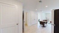 This well-appointed one-bedroom, one-bathroom unit at 523 Chestnut Ave in Woodbury Heights, NJ offers a thoughtfully designed layout with a clean, contemporary aesthetic. Light wood-style flooring flows throughout the space, complemented by crisp white walls that maximize brightness in every room.

The kitchen features white flat-front cabinetry extending to the ceiling, stainless steel appliances including a refrigerator, range, microwave, and dishwasher, along with a single-basin sink and light countertops. A compact dining area adjacent to the kitchen provides a practical space for everyday meals.

The living room is bright and inviting, with a large window allowing natural light and outdoor views of the surrounding neighborhood. The open layout accommodates comfortable seating and a defined lounge area, creating a relaxed atmosphere.

The bedroom is a serene retreat, featuring a generous window with views of the exterior, light flooring, and clean white walls that lend a calm, airy feel. A dedicated closet provides convenient storage.

The bathroom is finished with white cabinetry, a framed mirror, vanity lighting, a single-sink vanity with ample storage, and light wood-style flooring that carries the cohesive design throughout. The overall ambiance of the unit is modern, minimal, and move-in ready.