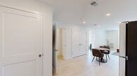 This well-appointed one-bedroom, one-bathroom unit at 523 Chestnut Ave in Woodbury Heights, NJ offers a thoughtfully designed layout with a clean, contemporary aesthetic. Light wood-style flooring flows throughout the space, complemented by crisp white walls that maximize brightness in every room.

The kitchen features white flat-front cabinetry extending to the ceiling, stainless steel appliances including a refrigerator, range, microwave, and dishwasher, along with a single-basin sink and light countertops. A compact dining area adjacent to the kitchen provides a practical space for everyday meals.

The living room is bright and inviting, with a large window allowing natural light and outdoor views of the surrounding neighborhood. The open layout accommodates comfortable seating and a defined lounge area, creating a relaxed atmosphere.

The bedroom is a serene retreat, featuring a generous window with views of the exterior, light flooring, and clean white walls that lend a calm, airy feel. A dedicated closet provides convenient storage.

The bathroom is finished with white cabinetry, a framed mirror, vanity lighting, a single-sink vanity with ample storage, and light wood-style flooring that carries the cohesive design throughout. The overall ambiance of the unit is modern, minimal, and move-in ready.