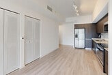 Located at 22555 SW 107th Ave in Miami, FL, this well-appointed three-bedroom, two-bathroom single-floor residence offers a clean, modern aesthetic throughout. Light wood-style flooring flows seamlessly across every room, complementing the bright white walls and creating a cohesive, contemporary atmosphere.

The open-concept living and dining area is anchored by large sliding glass doors that invite abundant natural light and provide views of the outdoors. The kitchen is thoughtfully designed with dark wood cabinetry extending to the ceiling, granite countertops, a subway tile backsplash, and a full suite of stainless steel appliances including a refrigerator, range, microwave, and dishwasher. Track lighting adds a modern touch overhead.

Each of the three bedrooms features large windows with horizontal blinds that frame lush outdoor greenery, keeping the spaces bright and airy. The primary bedroom includes a dedicated closet, while additional bedrooms offer built-in wardrobe storage with sleek, modern hardware.

Both bathrooms are finished with granite-topped dark vanities, large mirrors with bar lighting, and light wood-style flooring. One bathroom features a full tub-shower combination. The home also includes a dedicated laundry area, utility room, and ample closet storage throughout, rounding out a practical and polished living space.