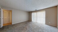 Located at 608 S Eastern St in Wichita, Kansas, this single-story, two-bedroom, one-bathroom home offers a practical and comfortable layout. Throughout the living areas and bedrooms, neutral-toned carpet provides a warm underfoot feel, while textured ceilings add a classic finishing touch.

The living area is generously sized, featuring large sliding glass doors dressed with vertical blinds that allow ample natural light to filter in and provide access to the outdoors. The space offers a clean, open canvas well-suited for a variety of furniture arrangements.

The kitchen is efficiently laid out with warm wood-toned cabinetry, white countertops with tiled backsplash, and tile flooring. It is equipped with a dishwasher and electric range, providing all the essentials for everyday cooking.

The spacious primary bedroom also benefits from a large sliding glass door with vertical blinds, filling the room with natural light. A second bedroom features carpeted flooring, neutral walls, and a window with blinds.

The bathroom is well-appointed with a long vanity, dual mirrors with louvered medicine cabinets, warm wood cabinetry, white countertops, and tile flooring, offering ample storage and counter space.

Two closets provide additional storage throughout the home, rounding out this tidy and functional Wichita residence.