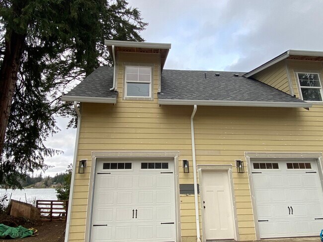 Pre-painted front ext. Apartment are the two left doors. - 1090 Kitsap Lake Rd NW