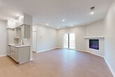Located at Parker Plaza in Omaha, Nebraska, this well-appointed 2-bedroom, 3-bathroom unit offers a thoughtfully designed single-level layout with modern finishes throughout. The open-concept kitchen and living area serves as the heart of the home, where light wood-look flooring flows seamlessly underfoot. The kitchen is outfitted with gray shaker-style cabinetry, stone-look countertops, a classic white tile backsplash, stainless steel appliances, and recessed lighting — creating a clean, functional space. The living room features a striking stone-surround fireplace and sliding glass doors that open onto a private balcony, bringing in natural light and outdoor views. Both bedrooms are carpeted for comfort, with neutral walls and ample closet space, including a double bifold closet in the primary bedroom. The bathrooms are finished with light wood-look flooring, gray vanity cabinetry, stone-look countertops, and brushed nickel fixtures. One bathroom includes a soaking tub, while others offer clean, streamlined designs. A dedicated closet adds convenient storage. The overall aesthetic is bright, clean, and contemporary — ideal for comfortable everyday living.