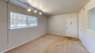 Located at 100 Kimball Ave in Salem, Virginia, this single-floor, 2-bedroom, 1-bathroom unit offers a practical and well-organized layout. The living room greets you at the entrance, featuring plush carpeting, track lighting, and a window that brings in natural light, creating a welcoming atmosphere. The adjacent kitchen is equipped with warm wood cabinetry, dark countertops, tile flooring, a skylight, and a full suite of white appliances including a range with overhead microwave, dishwasher, and refrigerator — providing ample functionality for everyday cooking. Both bedrooms are carpeted and include ceiling fans for comfort. The primary bedroom offers a generous footprint, while the second bedroom features a window with views of the surrounding greenery and double closet doors for storage. The full bathroom includes a soaking tub with tiled surround and tile flooring, and conveniently houses in-unit washer and dryer connections behind a louvered closet door. Neutral tones throughout the unit create a clean, cohesive aesthetic that is easy to personalize. This unit offers a comfortable and efficient living environment in a residential Salem, VA setting.