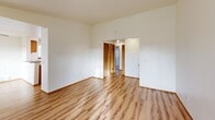 Located in Lakewood, WA, this single-floor residence offers three bedrooms, four bathrooms, and a thoughtfully arranged layout across a comfortable footprint. The living room serves as the heart of the home, featuring warm hardwood-style flooring, a classic brick corner fireplace, and a large window that fills the space with natural light. A hallway connects the living area to the rest of the home, maintaining a practical and efficient flow throughout.

The combined dining room and kitchen area is well-appointed with warm wood cabinetry, grey laminate countertops, a double stainless steel sink, and white appliances including an electric range and built-in microwave. A window above the kitchen provides additional natural light. The space opens directly toward the living room, creating a connected, social atmosphere.

The three bedrooms are generously proportioned, with the primary bedroom offering its own dedicated space. The secondary bedrooms feature plush carpet flooring and sliding wood-panel closet doors, offering practical storage. Five closets are distributed throughout the home for additional organization.

The four bathrooms are cleanly finished, featuring wood-framed mirrors, neutral countertops, and tub/shower enclosures with light-toned surrounds. An in-unit laundry area adds everyday convenience, rounding out a well-equipped and functional home.