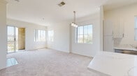 Located at 9320-9370 Hillery Dr in San Diego's Mira Mesa community, this single-floor residence offers a clean, contemporary design with a bright and airy atmosphere throughout. The open-concept living and dining area is anchored by plush neutral carpeting and features multiple large windows that frame views of the surrounding greenery, flooding the space with natural light. A stylish pendant chandelier adds a refined touch to the dining area, which flows seamlessly from a quartz-topped kitchen peninsula.

The kitchen is well-appointed with white shaker cabinetry, quartz countertops, stainless steel appliances including a refrigerator, electric range, and built-in microwave, and durable wood-look flooring. A built-in shelving nook adjacent to the kitchen provides additional storage and display space.

The bedrooms are generously sized, each featuring soft carpeting and windows with outdoor views, filling the rooms with natural light. The bathrooms are finished with quartz vanity countertops, white shaker cabinetry, undermount sinks, chrome fixtures, full tub-shower combinations, and wood-look flooring. A dedicated in-unit laundry closet with a full-size washer and dryer adds everyday convenience to this well-designed residence.