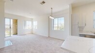 Located at 9320-9370 Hillery Dr in San Diego's Mira Mesa community, this single-floor residence offers a clean, contemporary design with a bright and airy atmosphere throughout. The open-concept living and dining area is anchored by plush neutral carpeting and features multiple large windows that frame views of the surrounding greenery, flooding the space with natural light. A stylish pendant chandelier adds a refined touch to the dining area, which flows seamlessly from a quartz-topped kitchen peninsula.

The kitchen is well-appointed with white shaker cabinetry, quartz countertops, stainless steel appliances including a refrigerator, electric range, and built-in microwave, and durable wood-look flooring. A built-in shelving nook adjacent to the kitchen provides additional storage and display space.

The bedrooms are generously sized, each featuring soft carpeting and windows with outdoor views, filling the rooms with natural light. The bathrooms are finished with quartz vanity countertops, white shaker cabinetry, undermount sinks, chrome fixtures, full tub-shower combinations, and wood-look flooring. A dedicated in-unit laundry closet with a full-size washer and dryer adds everyday convenience to this well-designed residence.
