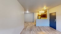 Located in Vancouver, WA, this single-floor, 2-bedroom, 2-bathroom unit offers a thoughtfully designed layout with modern finishes throughout. The open-concept living and dining area flows seamlessly into the kitchen, which is highlighted by rich walnut-toned cabinetry, stainless steel appliances including a refrigerator, range, microwave, and dishwasher, and light-toned countertops. A kitchen peninsula with pendant lighting adds both style and functionality, while a pantry provides generous storage.

The living area features light wood-style flooring that extends through the main living spaces, and a door with an adjacent window allows for natural light and outdoor access. The bedrooms are carpeted for comfort, each offering closet storage, with the primary bedroom providing a more spacious retreat. Both bathrooms are appointed with wood-toned vanities, light countertops, and well-lit mirrors.

A dedicated laundry room with a full-size washer and dryer adds everyday convenience, complemented by a utility room and additional closet storage. The clean, neutral color palette and consistent finishes throughout create a cohesive and move-in-ready living environment.