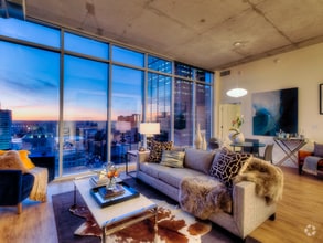 Bask in floor to ceiling windows with city views at One Light Luxury Apartments - One Light Luxury Apartments