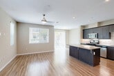 Located at 1630 Paseo Monti in Chula Vista, CA, this three-story home offers four bedrooms, eight bathrooms, and a thoughtfully designed layout spread across three distinct floors. The entry level provides an expansive footprint encompassing an open-concept living and dining area with wood-look flooring, a ceiling fan, and abundant natural light from multiple windows. The modern kitchen is a standout, featuring dark wood cabinetry, stainless steel appliances, a marble-style backsplash, quartz countertops, and a central island with bar seating. A private balcony extends the living space outdoors. The mid-level floor continues the home's functional layout with additional bedrooms, hallways, and bathrooms. Bedrooms are carpeted, bathed in natural light through large windows, and offer pleasant outdoor views. The bathrooms are well-appointed, highlighted by a dual-sink vanity with dark cabinetry, quartz countertops, and modern fixtures. A dedicated laundry room houses a full-size Whirlpool washer and dryer. The uppermost level provides a more intimate footprint with additional living space. Three closets and an attached two-car garage with an automatic opener round out this well-equipped Chula Vista home.
