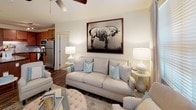 Located at 611 Templeton Ave in Charlotte's 28203 zip code, this single-story residence offers a thoughtfully designed layout with cohesive finishes throughout. The living area provides a welcoming, light-filled space with wood-style flooring, a ceiling fan, and a large window dressed with elegant drapes, creating a comfortable and airy atmosphere that flows naturally toward the kitchen.

The kitchen is well-appointed with rich wood cabinetry extending to the ceiling for generous storage, dark granite countertops, a tile backsplash, and a full suite of stainless steel appliances including a refrigerator, range, microwave, and dishwasher. Track lighting and wood-style flooring complete the functional yet stylish space.

The bedrooms feature plush carpeting and ceiling fans, with ample natural light provided by blinds-fitted windows. Each room offers a calm, neutral palette conducive to rest and relaxation.

The bathrooms are finished with warm wood-tone cabinetry, granite-topped vanities, and wood-style flooring. Walk-in closets with built-in shelving are accessible directly from the bathrooms, offering practical and organized storage solutions throughout this well-considered Charlotte residence.
