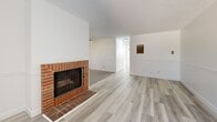 Located in Glendale, CA, this well-appointed 2-bedroom, 2-bathroom residence offers a thoughtfully designed single-floor layout. The open living room serves as the heart of the home, highlighted by a classic brick fireplace, light wood-style flooring, textured ceilings, and a window that brings in natural light. The space connects seamlessly to the rest of the unit via a central hallway.

The kitchen is efficiently laid out in a U-shape, featuring white shaker cabinetry, dark stone countertops, a subway tile backsplash, stainless steel appliances including a gas range and microwave, and a large window with views of the surrounding greenery. Tile flooring and recessed track lighting complete the functional, modern aesthetic.

Both bedrooms offer light wood-style flooring, textured ceilings, ceiling fans, wall-unit air conditioning, and windows that allow natural light to filter in. The primary bedroom provides a comfortable sense of space, while the second bedroom is equally well-lit and functional.

The two bathrooms are finished with gray tile flooring and white cabinetry with stone-topped vanities. One bathroom includes a shower-tub combo, while the other features a standalone shower. Throughout the residence, a clean, neutral color palette and consistent finishes create a cohesive and move-in-ready environment.