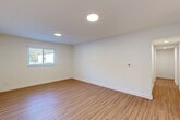 Located on Memorial Drive SE in Atlanta's 30317 corridor, this thoughtfully updated single-story home offers three bedrooms, two bathrooms, and a well-organized layout designed for comfortable everyday living. Wood-look flooring flows consistently throughout the home, lending a warm, cohesive feel to every room.

The living area is bright and open, illuminated by recessed lighting and natural light from well-placed windows. The kitchen features white shaker-style cabinetry, granite countertops, stainless steel appliances, and a stacked washer and dryer conveniently integrated into the space, maximizing functionality.

Each bedroom is finished with the same wood-look flooring, clean white walls, and windows fitted with blinds that provide views of the surrounding greenery. The spacious primary bedroom includes a ceiling fan and ample natural light. Connecting hallways keep the layout efficient and easy to navigate.

Both bathrooms are finished with neutral tile flooring, granite-topped white vanities, and matte black hardware. The full bath features a tub-shower combination with classic white subway tile accented by a sage green tile border, while the second bath includes a tiled shower. Together, these spaces reflect a clean, contemporary aesthetic throughout the home.