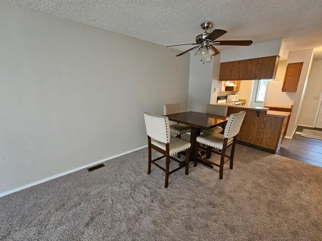 Dining area with ceiling fan. - 3509 Queen Anne Way