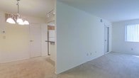 This single-floor space features a straightforward, open layout designed for practical everyday living. The main living area is finished with wall-to-wall carpet in a neutral tone, providing a comfortable and cohesive foundation throughout the space. Crisp white walls contribute to a clean, airy feel, while a partial dividing wall separates the living area from the kitchen without fully enclosing either space, maintaining a sense of openness and visual connectivity between the two zones.

The kitchen is accessible beyond the partial wall and is equipped with a white refrigerator and features warm-toned wood cabinetry overhead. A dark countertop offers workspace, and track lighting installed on the kitchen ceiling provides focused illumination in the cooking area. A door visible from the main living space leads to an additional room, and another door provides access likely to a closet or secondary space, adding to the unit's overall functionality.

Ventilation is provided through a ceiling-mounted vent, and multiple electrical outlets are positioned along the baseboards of the living area. The overall ambiance is neutral, bright, and move-in ready.