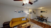 This single-floor residence offers a thoughtfully designed layout that balances comfort and functionality across its key living areas. The open-concept living and dining space serves as the heart of the home, featuring warm wood-look flooring, a textured ceiling, and a ceiling fan that adds to the comfortable ambiance. The living area provides access to a patio through sliding glass doors, allowing natural light to filter in. Adjacent to the living space, the dedicated dining area offers an intimate setting, accented by framed artwork on neutral-toned walls.

The galley-style kitchen is efficiently organized with white cabinetry, granite-look countertops, a stainless steel sink, and stainless steel appliances including a refrigerator, microwave, and dishwasher. Track lighting overhead illuminates the workspace, and a pass-through connects the kitchen to the living and dining areas.

The two bedrooms are carpeted for added comfort and each features a ceiling fan with light fixture. The primary bedroom includes an en-suite bathroom complete with a tub-shower combination, a granite-top vanity, and wood-look flooring. A second full bathroom mirrors this style with a similar vanity and tiled tub-shower. The cohesive neutral palette and consistent finishes throughout give the space a polished, unified feel.