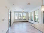 Located at 1050 Beckoning Blvd in Charlotte, NC, this 2-bedroom, 2-bathroom residence offers a thoughtfully designed single-floor layout that blends comfort and functionality. The open-concept kitchen and living area serves as the heart of the home, featuring light wood-style flooring, large windows, and a ceiling fan that fills the space with natural light and lush outdoor views. The kitchen is well-appointed with gray shaker-style cabinetry, granite countertops, a central island with pendant lighting, subway tile backsplash, and a full suite of stainless steel appliances. A hallway connects the main living area to the private quarters, with a louvered-door laundry closet conveniently along the way. The primary bedroom is generously sized, wrapped in windows on two walls that frame verdant tree canopy views, and includes its own closet. The second bedroom features plush carpet flooring and bright window views of the surrounding community. Both bathrooms are finished with tile flooring, granite-topped vanities, and a tub-shower combination. Each bedroom is served by a dedicated closet with wire shelving. A private balcony extends the living space outdoors, rounding out this well-appointed Charlotte residence.