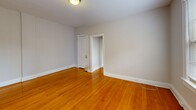 Located at 405 10th St NE in Washington, DC's Capitol Hill neighborhood, this one-bedroom, one-bathroom unit offers a well-organized, single-floor layout. Warm hardwood floors run throughout the living spaces and bedroom, lending continuity and a classic feel to the interior. The combined living and dining room is bright and open, featuring multiple windows that admit generous natural light and views of the surrounding brick streetscape. A wall-mounted HVAC unit provides climate control. The bedroom is a comfortable, well-proportioned space with its own window and direct access to two closets, offering ample storage. A hallway connects the main rooms and leads to a dedicated entrance. The kitchen is efficiently arranged with warm wood cabinetry, dark countertops, a stainless steel sink, a dishwasher, and a full-size refrigerator. Tile flooring in the kitchen provides a practical transition from the hardwood elsewhere. The bathroom is finished with classic black-and-white octagonal floor tile, a white vanity, a full soaking tub with overhead shower, and a frosted window that provides natural light while maintaining privacy. Two closets throughout the unit add to the overall functionality of this well-maintained Capitol Hill residence.