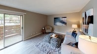 This single-floor residence is thoughtfully designed with a neutral, warm color palette that flows cohesively throughout. The living area is generously proportioned, featuring wood-style laminate flooring, a textured ceiling, and a sliding door that introduces natural light. The space accommodates a comfortable seating arrangement and opens to an adjacent dining area.

The kitchen is a standout feature, offering an abundance of grey cabinetry, granite countertops, and a large peninsula with a built-in sink—ideal for meal preparation and casual dining. Stainless steel appliances, including a refrigerator and over-the-range microwave, complement the sleek electric range and dishwasher.

The bedrooms are carpeted and well-sized, each featuring sliding mirrored or panel closets and windows that allow natural light. The primary bedroom comfortably fits a large bed and additional furnishings.

Two bathrooms serve the residence. The primary bathroom features a tiled walk-in shower with glass enclosure and granite-topped vanity. The secondary bathroom offers a full tub-shower combo with a matching granite vanity. Both bathrooms feature light tile flooring and warm neutral walls, maintaining the home's consistent and polished aesthetic.