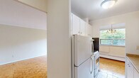 Located at 22 Elkhorn Dr in Toronto's Bayview Village neighbourhood, this 2-bedroom, 1-bathroom unit offers a well-organized single-floor layout comprising a living room, two bedrooms, kitchen, bathroom, hallway, and entrance. Warm parquet flooring runs throughout the main living areas, lending a classic character to the space. The spacious living room is a standout feature, bathed in natural light through large sliding glass doors that open onto a balcony, framing lush treetop views. An additional side window further enhances the bright and airy atmosphere. The galley-style kitchen features white cabinetry, stone-effect countertops, a stainless steel sink, white appliances, and tile flooring, with a window overlooking greenery. The primary bedroom is a comfortable size and includes a large sliding-door closet, while both bedrooms are equipped with wide windows and baseboard heaters, providing pleasant natural light and garden views. The bathroom includes a full tub-shower combination with beige and sage tile surround and a vanity with mirror. Crown moulding in the living area and neutral tones throughout give the unit a clean, cohesive finish.