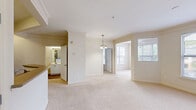 Located at 6000 Scarlet Sky Ln in Cary, NC, this well-appointed one-bedroom, one-bathroom residence offers a thoughtfully designed single-floor layout with a bright and welcoming atmosphere throughout. The open-concept kitchen and living area serves as the heart of the home, where white cabinetry, stainless steel appliances — including a refrigerator, electric range, and built-in microwave — and a wraparound breakfast bar combine for both style and functionality. A skylight above the kitchen adds natural brightness, while built-in shelving nearby provides convenient storage. The dining area flows seamlessly into the living space, featuring elegant crown molding, plush neutral carpeting, and a decorative chandelier that adds a classic touch. Natural light streams in through multiple windows throughout the unit. The bedroom is a comfortable retreat with a ceiling fan, a large window framing outdoor greenery, and direct access to a walk-in closet equipped with wire shelving and hanging rods. The full bathroom features wood-look flooring, a tub-shower combination with tile surround, and a vanity with ample cabinet storage. A dedicated in-unit laundry area completes this efficient and comfortable home.