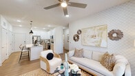 Located at 7135 Mount Zion Circle in Morrow, GA, this well-appointed 2-bedroom, 2-bathroom residence offers a thoughtfully designed single-level layout with modern finishes throughout. Light wood-tone flooring flows seamlessly across every room, creating a warm and cohesive aesthetic.

The kitchen is a standout feature, boasting a large granite-topped island with an undermount sink and pendant lighting, crisp white upper cabinetry paired with natural wood-toned lower cabinets, and a full suite of stainless steel appliances including a gas range, built-in microwave, refrigerator, and dishwasher. It opens directly into the living room, which is anchored by a ceiling fan, recessed lighting, a set of French doors that invite natural light, and a textured accent wall that adds character to the space.

Both bedrooms are comfortably sized, featuring ceiling fans, large windows with outdoor views, and light wood flooring. The primary bedroom offers a bright and restful retreat, while the second bedroom is equally well-lit and versatile. Each bathroom is finished with wood-tone vanity cabinetry, granite countertops, framed mirrors, and stylish fixtures, maintaining the modern design language found throughout the home. A dedicated hallway and closet complete the functional layout of this clean, contemporary residence.
