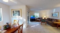 Located at 3499 Cortese Cir in San Jose, California, this single-story residence offers a well-organized floor plan designed for comfortable everyday living. The layout flows naturally between the main living and dining areas, with consistent neutral-toned carpeting and light wall colors throughout creating a cohesive and inviting atmosphere.

The living room is a generously proportioned space anchored by large sliding glass doors and a picture window that frame views of surrounding greenery, filling the room with natural light. A textured ceiling adds subtle architectural detail, while the open sightlines to the dining area enhance the sense of space.

The dining area is a defined yet connected space, featuring a ceiling fan with overhead lighting and a window overlooking lush outdoor vegetation, contributing a serene, garden-adjacent quality. Framed artwork on the walls adds a refined touch.

The kitchen follows a galley-style configuration, with warm wood cabinetry, granite-toned countertops on both sides, tile flooring, and white appliances, offering a functional and efficient workspace.

The bedroom is a quiet, carpeted retreat with windows allowing natural light and views of the surrounding landscape. The bathroom includes a wood-toned vanity with a generous countertop, tile flooring, and a well-lit mirror above the sink. A sliding glass door provides direct outdoor access from the living area.