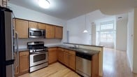Located at 2100 Round Pointe Drive in Haverstraw, NY, this two-story residence offers a well-designed floor plan with two bedrooms, two bathrooms, and a loft. The layout spans two floors, providing distinct living zones and a sense of vertical spaciousness.

The kitchen is a standout feature, outfitted with warm honey-toned wood cabinetry, dark granite countertops, and a classic subway tile backsplash. Stainless steel appliances — including a gas range, built-in microwave, and dishwasher — complete the functional setup. A peninsula with a double sink opens the kitchen toward the adjoining living area, enhancing the open-concept flow. A pendant light fixture above the peninsula adds a clean, modern touch.

Hardwood flooring runs throughout the main level, lending warmth and continuity to the space. Large windows invite abundant natural light into the living area, creating a bright and airy atmosphere. The loft level adds flexible space that can serve as a home office, reading nook, or additional lounge area.

With its combination of modern finishes, thoughtful layout, and multi-level design, this residence offers a comfortable and versatile living experience in the Hudson Valley community of Haverstraw.