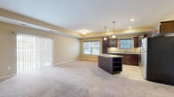 Located at 1015 Hope St in Mankato, Minnesota, this well-appointed 2-bedroom, 2-bathroom residence offers a comfortable and functional single-floor layout. The open-concept living, dining, and kitchen area forms the heart of the home, bathed in natural light from large windows and a sliding glass door that leads to a private balcony. Warm neutral tones and plush carpeting throughout create an inviting ambiance.

The kitchen is a standout feature, showcasing rich dark-wood cabinetry, granite countertops, a central island with additional storage, stainless steel appliances, and elegant pendant lighting — all set atop tile flooring that transitions seamlessly into the carpeted living areas.

Both bedrooms are generously sized, offering soft carpeting, natural light, and ample closet space. The primary bedroom is notably spacious and well-proportioned. The two bathrooms are clean and functional, one featuring a tub-shower combination and the other a walk-in shower with brushed nickel fixtures.

Additional highlights include an in-unit laundry room, a utility room, and multiple closets for abundant storage. The warm color palette, thoughtful layout, and quality finishes make this a comfortable and practical residence in Mankato.
