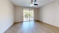Located at 150 Bear Springs Drive in Winter Springs, Florida, this well-appointed two-bedroom, two-bathroom residence offers a thoughtfully designed single-floor layout with a bright, open feel throughout. The combined living, dining, and kitchen area serves as the heart of the home, featuring light wood-look flooring, a ceiling fan, and sliding glass doors that open to a private balcony overlooking a lush tropical courtyard with palm trees and a pool area below.

The kitchen is outfitted with warm wood-toned cabinetry, granite countertops, stainless steel appliances, a built-in microwave, and a peninsula island with pendant lighting that provides additional prep and seating space. A pantry and in-unit laundry add everyday convenience.

Both bedrooms are carpeted and offer a quiet, comfortable retreat, with the primary bedroom featuring generous proportions. The five closets throughout the unit—including walk-in closet space with wire shelving systems—provide abundant storage. Both bathrooms are finished with wood-grain vanities, granite countertops, and framed mirrors.

Neutral tones and clean lines give the space a modern yet inviting ambiance, well-suited for everyday living in the sunny Central Florida climate.