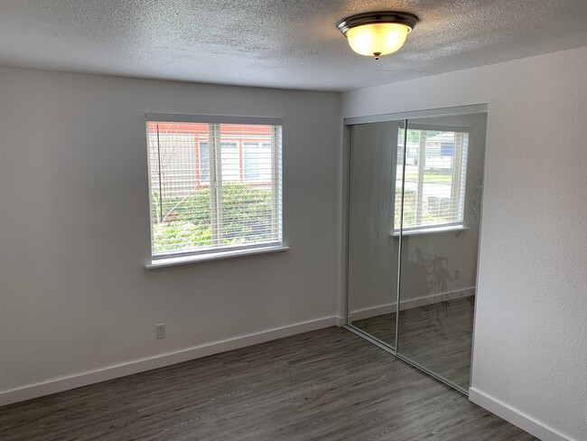 Bedroom #1 has ALL NEW LVP Floors, Blinds, Mirrored Closet Doors, Light Fixtures, and Fresh Paint. - 212 Spruce St E