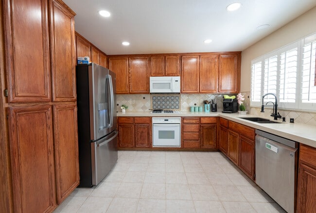 Bright kitchen featuring new GE refrigerator and LG dishwasher - 8781 Arbor St