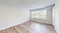 Located at 938 E Fourth St in Bethlehem, PA, this 2-bedroom, 1-bathroom unit offers a well-designed single-floor layout that balances comfort and modern style. The open living and dining areas are finished with light-toned luxury vinyl plank flooring and crisp white walls, creating a bright and airy atmosphere. Large windows throughout invite generous natural light and offer views of the surrounding greenery.

The kitchen is a standout feature, showcasing grey shaker-style cabinetry, bold granite countertops with rich veining, a marble-inspired tile backsplash, and a full suite of stainless steel appliances including a gas range, built-in microwave, dishwasher, and French door refrigerator. A kitchen island with matching granite provides additional prep and dining space.

Both bedrooms are carpeted for comfort and include windows with outdoor views. The primary bedroom features a closet with paneled double doors. The unit includes four closets in total, offering ample storage throughout. The bathroom is finished with a tub/shower combination, brushed nickel fixtures, and a geometric-patterned tile floor. A hallway connects the rooms, completing this functional and attractively finished layout.