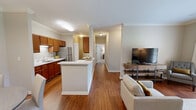 Located at 1300 Lovell Crossing Way in Knoxville, TN, this well-appointed single-story residence offers 2 bedrooms and 2 bathrooms across a comfortable and functional floor plan. Hardwood-style flooring flows throughout the main living areas, complemented by neutral wall tones and crown molding that add a refined touch.

The open-concept living room is bright and inviting, featuring French doors that allow natural light to pour in and offer views of the outdoors. The galley-style kitchen is well-equipped with rich wood cabinetry, white countertops, stainless steel appliances, and ample storage on both sides. It opens directly to a dedicated dining area illuminated by a pendant light fixture, creating a seamless space for everyday meals and entertaining.

The spacious primary bedroom features plush carpeting, a ceiling fan, and a natural light-filled window, with access to a generous walk-in closet equipped with wire shelving and a hanging rod. The second bedroom offers flexible use as a guest room or home office, also with carpet flooring. Both bathrooms include wood vanities and a tub/shower combination. A dedicated laundry area houses a stacked washer and dryer unit for added convenience. Two closets provide ample storage throughout the home.