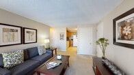 Located at 678 Princeton in Lowell, MA, this single-floor residence offers a well-organized layout designed for comfortable everyday living. The living room serves as the heart of the home, featuring neutral-toned walls, plush carpeting, and large windows that invite natural light. The open sightline connects the living area directly to the kitchen, creating a cohesive and functional flow throughout the space.

The kitchen is equipped with warm honey-toned oak cabinetry, ample counter space with dark laminate surfaces, and a full suite of white appliances including a refrigerator, stove, and dishwasher. Light tile flooring completes the clean, practical aesthetic of this well-appointed cooking space.

The residence includes two bedrooms, each carpeted and finished with neutral walls. The primary bedroom features a generous closet, a wide window framing outdoor views, and room for substantial furniture. The second bedroom is cozy and equally well-lit, offering a comfortable and private retreat.

The bathroom is finished with a clean, understated design, featuring a white vanity with a basin sink, an oversized mirror, and warm-toned walls that create a calm, functional environment. Throughout the home, the consistent use of neutral tones and carpeted floors contributes to a cohesive and inviting atmosphere.