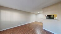 This well-organized one-bedroom, one-bathroom unit offers a functional and comfortable layout across a single floor. The open living and dining area is finished with warm wood-look flooring and neutral-toned walls, creating a clean, inviting atmosphere. A large window along one wall fills the living space with natural light, while a pass-through granite countertop visually connects the living area to the kitchen.

The galley-style kitchen is thoughtfully designed with dark cabinetry, granite countertops, a stainless steel sink, and a full-size refrigerator. A skylight overhead provides additional brightness, making the kitchen feel open despite its compact footprint.

The bedroom is carpeted for comfort and features a ceiling fan with light fixture, a window with outdoor views, and ample wall space for flexible furniture placement. Neutral tones throughout maintain a calm, cohesive aesthetic.

The bathroom is finished with wood-look flooring, a granite-topped vanity with an under-mount sink, and a separate water closet, providing a practical and organized layout. Closet storage is also available within the bathroom corridor. The entry area includes HVAC access and leads directly into the main living space, offering a logical and efficient flow throughout the unit.