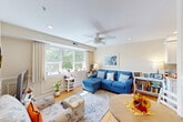 Located at 141 Chestnut St in Needham, MA, this well-appointed two-bedroom, one-bathroom residence offers a thoughtfully designed single-floor layout. Warm hardwood flooring flows throughout every room, tying the space together with a cohesive, inviting aesthetic. The entrance hallway features classic wainscoting panels that set an elegant tone, leading into the bright and comfortable living room. Large windows with shutters and draping curtains flood the living area with natural light and offer pleasant outdoor views, while a ceiling fan adds both style and function. The galley-style kitchen is equipped with white shaker cabinetry, light stone countertops, a subway tile backsplash, and stainless steel appliances including a gas range, refrigerator, and dishwasher. The primary bedroom is a well-sized retreat featuring dual windows, hardwood floors, a ceiling fan, and a double-door closet. The second bedroom offers flexibility as a home office or guest room, with ample natural light and its own closet. The full bathroom includes a glass-enclosed shower, a vanity with mirror, and tile flooring. With four closets distributed throughout, storage is plentiful. The space combines classic architectural details with modern finishes for a comfortable and functional living environment.