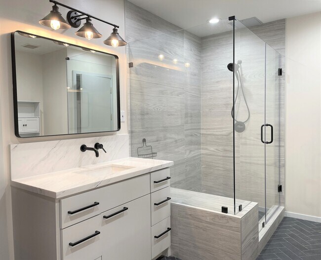 Updated bath with separate his and hers vanity, and large walk-in shower - 505 Bastrop St
