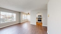 Located at 1318 N Mansfield Ave in the heart of Hollywood, Los Angeles, this one-bedroom, one-bathroom unit offers a well-designed layout across a single floor. The open living room is bright and welcoming, featuring wood-style flooring, neutral gray walls, a textured ceiling, and a ceiling fan with light fixture. Multiple windows fitted with horizontal blinds allow natural light to fill the space while offering views of the surrounding neighborhood. A wall-mounted AC unit provides climate control directly in the living area.

The kitchen is accessible through a distinctive arched entryway and is well-appointed with white shaker-style cabinetry, light stone countertops, and a full suite of stainless steel appliances, including a gas range, over-the-range microwave, dishwasher, and refrigerator. Wood-tone flooring in the kitchen complements the overall aesthetic.

The bedroom is a comfortable size, featuring the same wood-style flooring, a window for natural light, and a mirrored sliding closet that adds depth to the room. An arched hallway connects the bedroom to the rest of the unit.

The bathroom includes a full bathtub and shower combo with white tile surround. Throughout the unit, clean white trim and consistent flooring choices create a cohesive, move-in-ready feel.