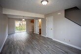 Located at 1175 Willow Run Dr in Abingdon, Virginia, this two-story home offers a functional and well-organized layout across both levels. The main floor features light-toned luxury vinyl plank flooring that extends through the open living area and into the galley-style kitchen. The kitchen is equipped with warm honey-toned wood cabinetry, white countertops, a stainless steel double-basin sink, and a white electric range, with a window providing natural light. A convenient half bathroom is also located on the main level, accessible directly from the living area. A carpeted staircase with white painted railings connects the main floor to the upper level. Upstairs, the bedrooms are finished with plush wall-to-wall carpeting and textured ceilings. Each bedroom offers generous proportions, and select rooms include windows that allow natural light and exterior views. One bedroom features a walk-in closet. The upper-level full bathroom includes a tub/shower combination, a wood-cabinet vanity with a white countertop, and tile-style flooring. Throughout the home, neutral wall tones and clean white trim create a cohesive, move-in-ready aesthetic suited for comfortable everyday living.