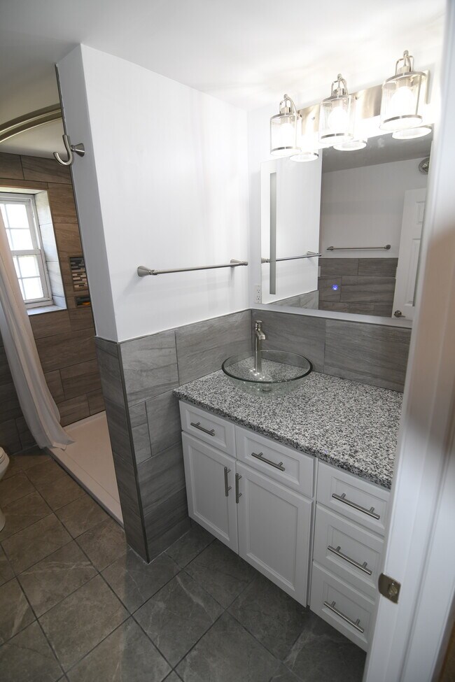 New fixtures, counter, cabinets, tile walls and floor, shower surround, toilet and lighting. - 309 Old York Rd