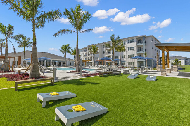 Gaming lawn featuring cornhole - Marlowe Jacaranda