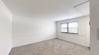 Located at 4838 Pulaski Ave in Philadelphia's 19144 zip code, this one-bedroom, one-bathroom unit offers a thoughtfully organized single-floor layout. The interior is finished with neutral white walls featuring a distinctive chair rail detail that runs throughout, creating a clean and consistent aesthetic. Soft carpet flooring covers the main living and bedroom areas, adding warmth underfoot.

The living room is a bright, open space with natural light filtering in through blinded windows, providing a comfortable area for relaxing or entertaining. The bedroom is generously sized for the overall footprint of the unit and includes a sliding closet, offering practical storage. In total, the unit benefits from three closets, providing ample storage throughout.

The bathroom is well-appointed with a full tub-shower combo, a white vanity with mirror cabinet, and wood-look tile flooring. A small window above the tub allows for natural light and ventilation. The kitchen connects conveniently through the hallway, which ties the rooms together efficiently.

Overall, this unit presents a clean, move-in-ready atmosphere with a bright and simple design palette, well-suited for those seeking a functional and low-maintenance living space in Philadelphia.