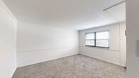 Located at 4838 Pulaski Ave in Philadelphia's 19144 zip code, this one-bedroom, one-bathroom unit offers a thoughtfully organized single-floor layout. The interior is finished with neutral white walls featuring a distinctive chair rail detail that runs throughout, creating a clean and consistent aesthetic. Soft carpet flooring covers the main living and bedroom areas, adding warmth underfoot.

The living room is a bright, open space with natural light filtering in through blinded windows, providing a comfortable area for relaxing or entertaining. The bedroom is generously sized for the overall footprint of the unit and includes a sliding closet, offering practical storage. In total, the unit benefits from three closets, providing ample storage throughout.

The bathroom is well-appointed with a full tub-shower combo, a white vanity with mirror cabinet, and wood-look tile flooring. A small window above the tub allows for natural light and ventilation. The kitchen connects conveniently through the hallway, which ties the rooms together efficiently.

Overall, this unit presents a clean, move-in-ready atmosphere with a bright and simple design palette, well-suited for those seeking a functional and low-maintenance living space in Philadelphia.