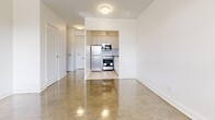 Located at 4750 Bathurst Street in Toronto's North York neighbourhood, this studio unit offers a well-organized single-floor layout that efficiently combines living and kitchen functions within a compact footprint. The open-concept living area is anchored by large, floor-to-ceiling windows that flood the space with natural light and frame pleasant views of the tree-lined street below. Polished parquet flooring runs throughout, adding warmth and a classic character to the bright, white-walled interior. A baseboard heating system runs along the windowed wall, ensuring year-round comfort.

The kitchen is neatly tucked into a defined nook, equipped with light-toned cabinetry, a stainless steel refrigerator, built-in microwave, and electric stove, providing all essential cooking amenities in a space-conscious design. A hallway connects the living area to the full bathroom, which features clean white subway tile surrounding a soaking bathtub and shower combination with chrome fixtures. The vanity area includes a sink and mirror, maintaining a crisp, modern aesthetic throughout. The unit's clean, neutral palette and efficient layout make it a practical and functional living space in a well-established Toronto neighbourhood.
